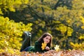 Beautiful teenage girl lying on yellow leaves in autumn. Royalty Free Stock Photo