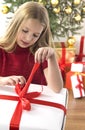 Beautiful teenage girl opening her christmas prese Royalty Free Stock Photo