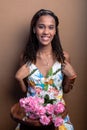 Beautiful teenage girl, sitting, with bouquet of flowers Royalty Free Stock Photo