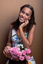 Beautiful teenage girl, sitting, with bouquet of flowers Royalty Free Stock Photo