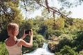 Beautiful teenage girl taking photo of waterfall. Krka waterfalls National park, Croatia Royalty Free Stock Photo