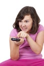 Beautiful teenage girl with tv remote control in her hands Royalty Free Stock Photo