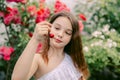 Beautiful teenage girl picking cherries, looks at her Royalty Free Stock Photo