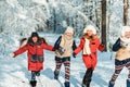 Beautiful teenage girls having fun outside in a wood with snow in winter. Friendship and active life consept Royalty Free Stock Photo