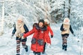 Beautiful teenage girls having fun outside in a wood with snow in winter. Friendship and active life consept Royalty Free Stock Photo