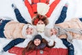 Beautiful teenage girls having fun outside in a wood with snow in winter. Friendship and active life consept Royalty Free Stock Photo