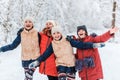 Beautiful teenage girls having fun outside in a wood with snow in winter. Friendship and active life consept Royalty Free Stock Photo