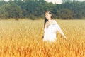 Beautiful Teenage Model girl Dressed in Casual Short Dress on the Field in Sun Light. Royalty Free Stock Photo