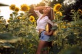 Beautiful Teenage Model girl with long healthy hair posing on the Sunflower Spring Field Royalty Free Stock Photo