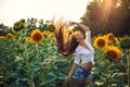 Beautiful Teenage Model girl with long healthy hair posing on the Sunflower Spring Field Royalty Free Stock Photo