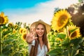 Beautiful Teenage Model girl with long healthy hair posing on the Sunflower Spring Field Royalty Free Stock Photo