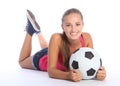 Beautiful teenage soccer girl lying on floor