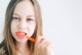 Beautiful teenager girl brushes her teeth large portrait