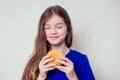 Beautiful teenager girl is eating baked vegetarian burger with vegetables. Child vegan idea healthy eating concept.clear