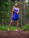 Beautiful teenager girl in high fashion dress posing in a forest park. Prom or special event. Young lady in classic outfit. Model Royalty Free Stock Photo