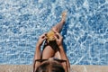 Beautiful teenager girl at the pool drinking healthy orange juice and having fun outdoors. Summertime and lifestyle concept. Top Royalty Free Stock Photo