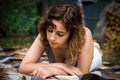 Beautiful teenager girl reading a book lying on blanket on green grass at the forest Royalty Free Stock Photo