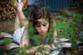 Beautiful teenager girl reading a book lying on blanket on green grass at the forest Royalty Free Stock Photo