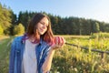 Beautiful teenager girl with red apple, happy young woman on nature