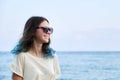 Beautiful teenager girl in sunglasses on sea beach, nature sea sky background for copy space Royalty Free Stock Photo