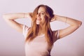 Beautiful teenager girl on a white background. The girl smiles and laughs, having fun. Girl in jeans and a t-shirt. Student Royalty Free Stock Photo