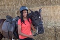 Beautiful teenager with his horse learning to ride Royalty Free Stock Photo