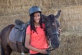 Beautiful teenager with his horse learning to ride Royalty Free Stock Photo