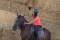 Beautiful teenager with his horse learning to ride Royalty Free Stock Photo