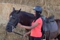 Beautiful teenager with his horse learning to ride Royalty Free Stock Photo