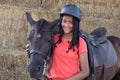 Beautiful teenager with his horse learning to ride Royalty Free Stock Photo