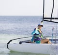 Beautiful teenager sailing catamaran in beautiful sunset Royalty Free Stock Photo