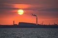 Beautiful telephoto view of epic orange sunset over Dublin port and Sun aligned with Covanta Plant Dublin Waste to Energy Royalty Free Stock Photo