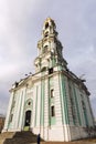 A beautiful temple with blue walls and golden domes against a blue sky. Vertical. Sergiev Posad, Russia, 11-18-2020 Royalty Free Stock Photo