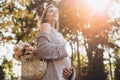 Beautiful tender blonde ?regnant woman standing in park. Free happy woman enjoying nature Royalty Free Stock Photo