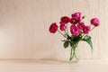 Beautiful tender pink roses in glass vase on the table with copy space. Minimal home decor. Festive floral backround