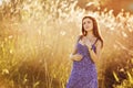 Beautiful tender pregnant woman smiles and enjoys a sunny summer Royalty Free Stock Photo