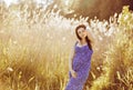 Beautiful tender pregnant woman smiles and enjoys a sunny summer Royalty Free Stock Photo