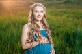 Beautiful tender pregnant woman standing on green grass Royalty Free Stock Photo