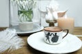 Beautiful tender stilllife, snowdrop, Galanthus in vase, small cup of coffee, cappuccino, candle, concept of coffeetime, romantic