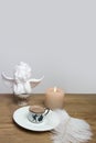Beautiful tender stilllife, snowdrop, Galanthus in vase, small cup of coffee, cappuccino, candle, concept of coffeetime, romantic