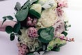 Beautiful tender wedding bouquet of cream roses and eustoma flowers lies on the table, soft focus Royalty Free Stock Photo
