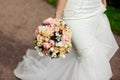 Beautiful tender wedding bouquet of roses and eustoma flowers in hands Royalty Free Stock Photo