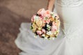 Beautiful tender wedding bouquet of roses and eustoma flowers in hands Royalty Free Stock Photo