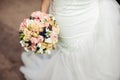 Beautiful tender wedding bouquet of roses and eustoma flowers in hands Royalty Free Stock Photo