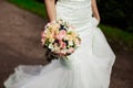 Beautiful tender wedding bouquet of roses and eustoma flowers in hands Royalty Free Stock Photo