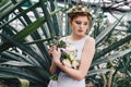 beautiful tender young redhead bride holding wedding bouquet in botanical Royalty Free Stock Photo