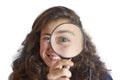 Beautiful tennager girl looking through a magnifying glass