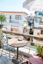 Beautiful terrace or balcony with small wooden table, chair and tree with evening city view Royalty Free Stock Photo