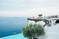 Beautiful terrace with pink chairs, people and sea view santorini island greece