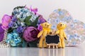 Beautiful textile Teddy bears and a bouquet of silk flowers, a gift box and a small black Board for notes, cozy home trifles Royalty Free Stock Photo